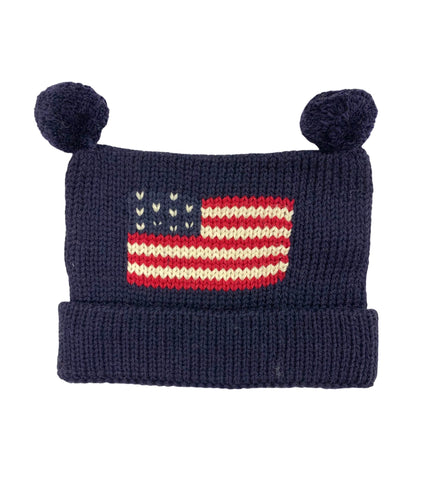 navy hat rolled up once at bottom with two navy poms at top, red, white and blue american flag in center