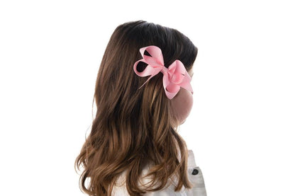 girl with light brown hair wearing medium sized bow