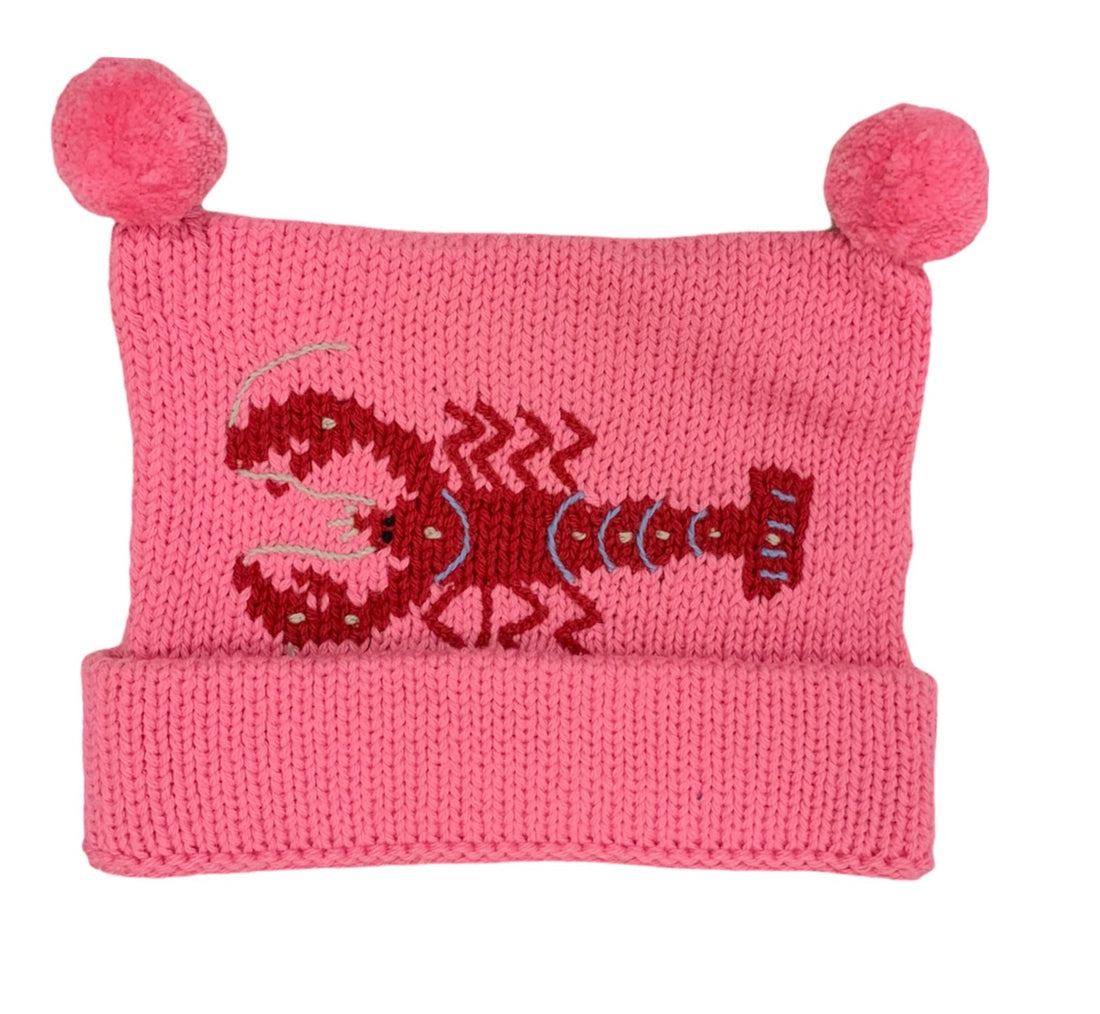 bright pink hat with bottom rolled up once and two poms at top, red horizontal lobster design in center