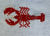 close up of red lobster knit design
