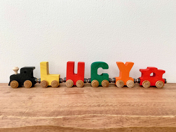 spelling out Lucy with caboose and engine