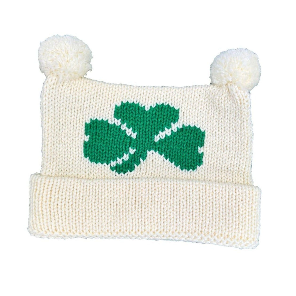 ivory hat, bottom is rolled up once with two poms at top, one green shamrock knitted in center