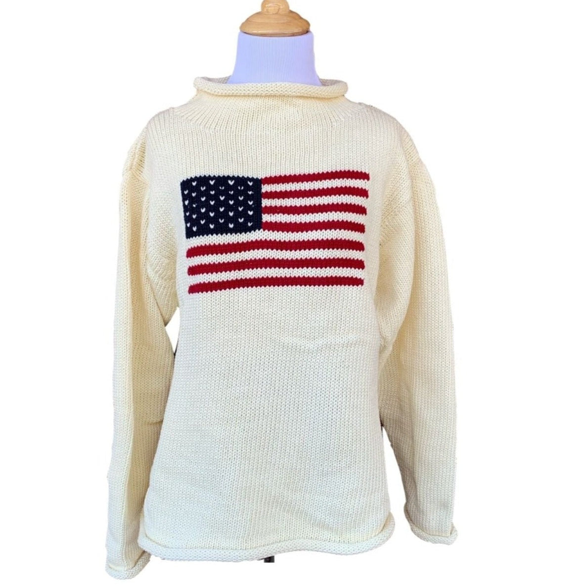 long sleeve ivory roll neck sweater with flag with red stripes and blue square with white stars in center of sweater