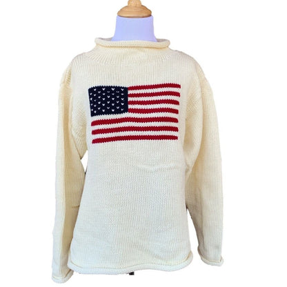 long sleeve ivory roll neck sweater with flag with red stripes and blue square with white stars in center of sweater