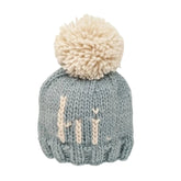blue knit beanie with hi in ivory and ivory pom