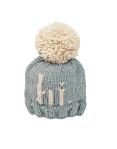 blue knit beanie with hi in ivory and ivory pom