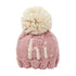 light rosy pink knit hat with natural hi and natural pom at top