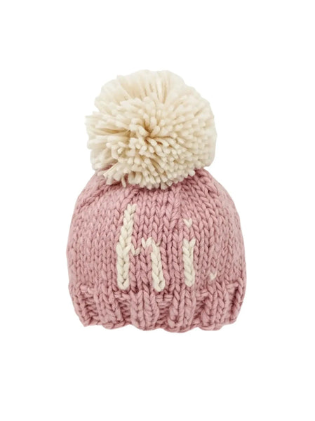 light rosy pink knit hat with natural hi and natural pom at top