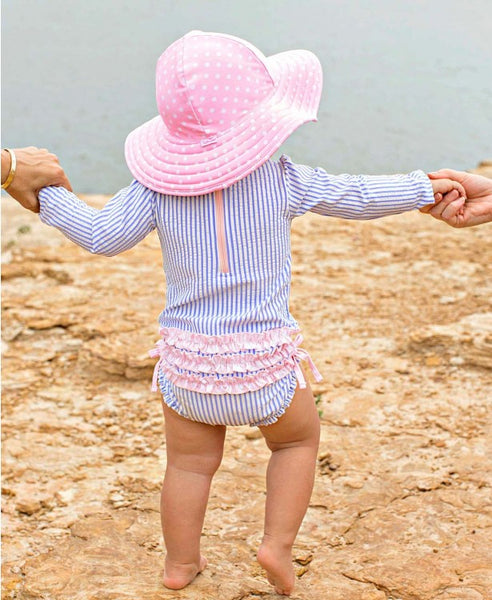 shows baby girl wearing bathing suit from behind