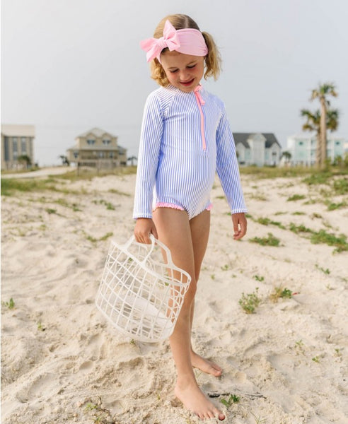 little girl wearing bathing suit on the beach