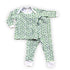 white pajamas with tiny green shamrocks in varying shades of green, white cuffs on ankles and arms with white trim on collar