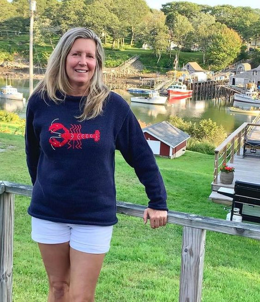 woman wearing Navy Lobster sweater with white shorts